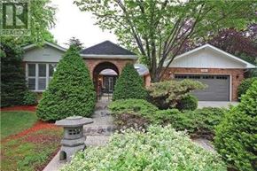 Oakville (Fd Ford) apartment for rent - A house with a red brick wall and a white garage door.