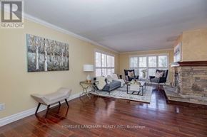 Oakville (Fd Ford) apartment for rent - A living room with a fireplace and a painting on the wall.