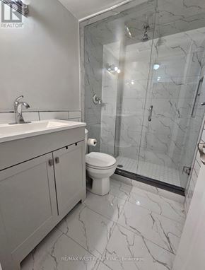Toronto (Mimico) apartment for rent - A bathroom with a marble floor and a walk-in shower.