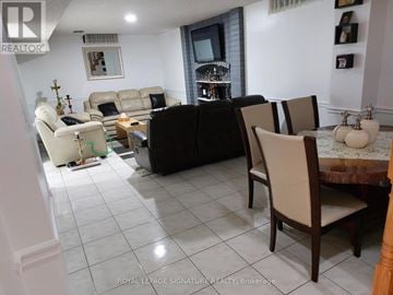 Brampton (Heart Lake West) apartment for rent - A living room with a black couch and a white sofa.