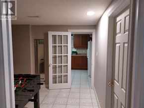 Brampton (Heart Lake West) apartment for rent - A room with a pool table and a door leading to another room.