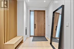 Toronto (Rosedale-Moore Park) apartment for rent - A hallway with a wooden door and a mirror on the wall.