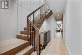 Toronto (Rosedale-Moore Park) apartment for rent - A modern staircase with wooden steps and metal railings.