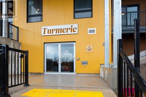 Barrie condo for rent - A yellow building with the word "Turmeric" on it.