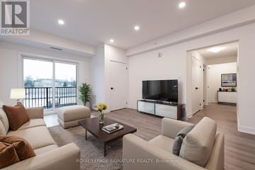 Barrie condo for rent - A living room with a white couch and a television.