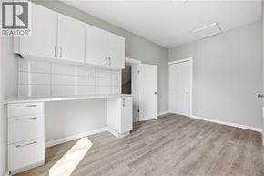 Wallaceburg apartment for rent - A room with white cabinets and a desk.