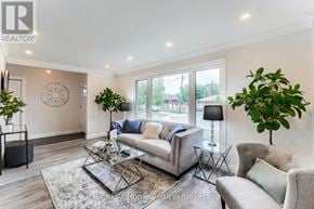 Hamilton (Corman) apartment for rent - A well-lit living room with a glass coffee table and a grey sofa.
