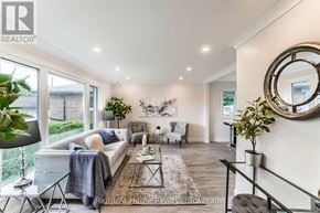 Hamilton (Corman) apartment for rent - A well-lit living room with a white sofa, a glass coffee table, and a large mirror on the wall.
