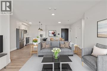 Windsor condo for rent - A modern living room with a grey couch and a coffee table.