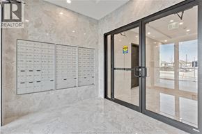 Windsor condo for rent - A glass door with a handle and a sign on it.