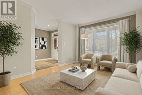 Ottawa apartment for rent - A living room with a white sofa, a coffee table, and a plant.