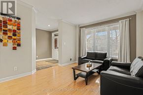 Ottawa apartment for rent - A living room with a black leather couch and a wooden coffee table.