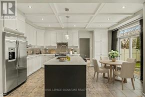Ottawa apartment for rent - A modern kitchen with a large island and a dining table set for four.