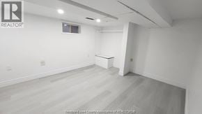 Windsor apartment for rent - A large empty room with a window and a white table in the corner.