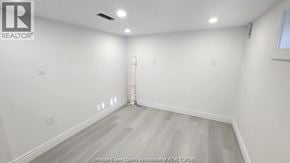 Windsor apartment for rent - A room with white walls and a wooden floor.