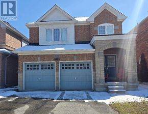 Oshawa (Taunton) apartment for rent - A house with a garage and a driveway in front of it.