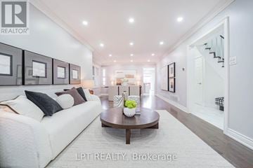 Markham (Middlefield) apartment for rent - A spacious living room with a white sofa and a coffee table.