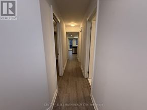 Barrie (Ardagh) apartment for rent - A long hallway with white walls and wood flooring.