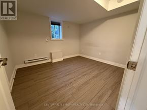 Barrie (Ardagh) apartment for rent - A room with wooden flooring and a window.