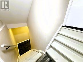 Barrie (Little Lake) apartment for rent - A staircase with a yellow wall on the side.
