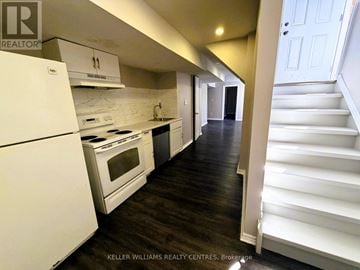 Barrie (Little Lake) apartment for rent - A white kitchen with a white fridge and stove.