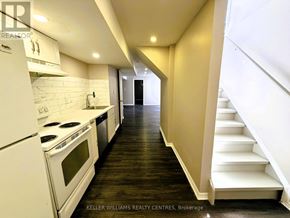 Barrie (Little Lake) apartment for rent - A modern kitchen with white appliances and wooden floors.