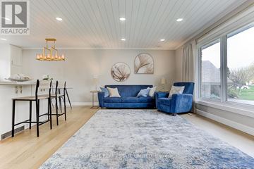 Oshawa (Donevan) apartment for rent - A living room with a blue couch and a rug.