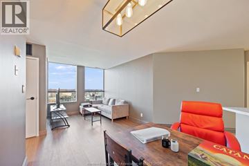 Windsor condo for rent - A living room with a red chair and a white couch.