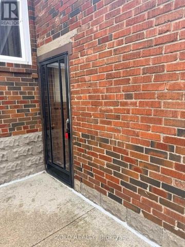 Toronto (Alderwood) apartment for rent - A brick wall with a door and a window.