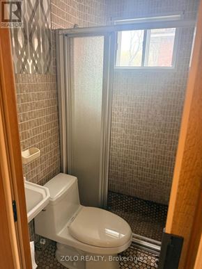 Toronto (Alderwood) apartment for rent - A bathroom with a toilet and a walk in shower.