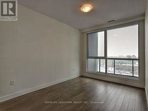 Kitchener condo for rent - A room with a large window and wooden flooring.