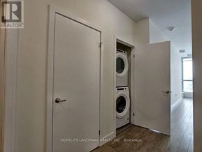 Kitchener condo for rent - A laundry room with a washer and dryer built into the wall.