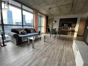 Toronto (Church-Yonge Corridor) condo for rent - A modern living room with a view of the city skyline.