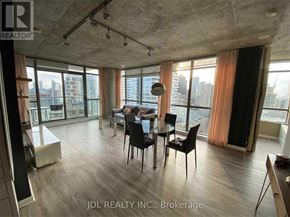 Toronto (Church-Yonge Corridor) condo for rent - A dining room with a table set for two and a view of the city.