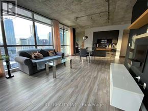 Toronto (Church-Yonge Corridor) condo for rent - A modern living room with a large window overlooking the city.