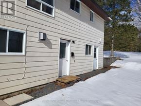 Huntsville (Chaffey) apartment for rent - A beige house with a white door and windows.