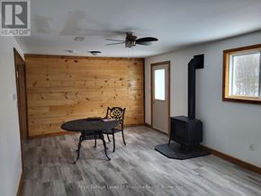Huntsville (Chaffey) apartment for rent - A wood panelled room with a table and chairs.