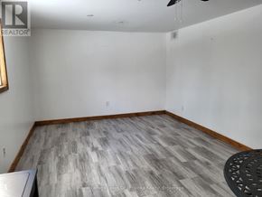 Huntsville (Chaffey) apartment for rent - A room with a wooden floor and a ceiling fan.