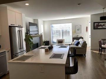 Langley apartment for rent - A modern kitchen with a refrigerator, stove, and oven.