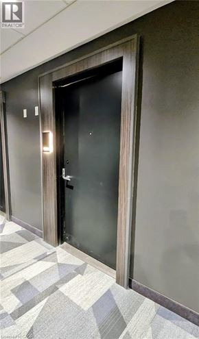 Kitchener condo for rent - A black door with a glass panel and a handle.