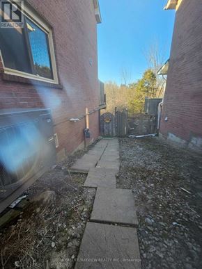 Aurora (Aurora Highlands) apartment for rent - A backyard with a brick wall and a wooden fence.