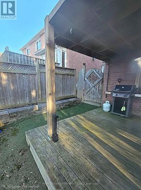 Aurora (Aurora Highlands) apartment for rent - A wooden deck with a pillar and a grill.