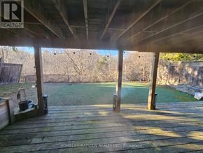 Aurora (Aurora Highlands) apartment for rent - A wooden deck with a view of a grassy area and trees.