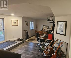 Aurora (Aurora Highlands) apartment for rent - A room with a brown couch, a desk with a computer, and guitars on the wall.