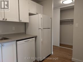 Ottawa multi-family for rent - A kitchen with white cabinets and a white refrigerator.