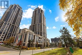 Toronto (Etobicoke West Mall) condo for rent - Two tall buildings are in the background of a tree with green leaves.