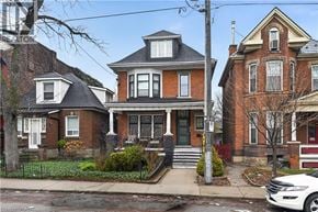 Hamilton apartment for rent - A white car is parked in front of a house.