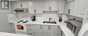 Markham (Raymerville) apartment for rent - A kitchen with white cabinets and appliances.
