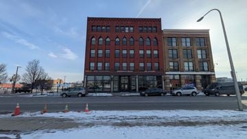 Buffalo apartment for rent - A red brick building with a parking lot in front of it.