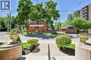 Hamilton condo for rent - A house with a red roof and a sign that says REALTOR in the corner.